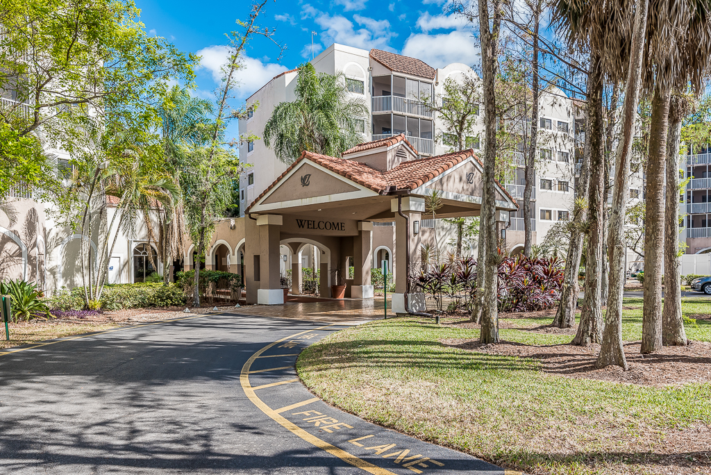 exterior image of community driveway entrance trees